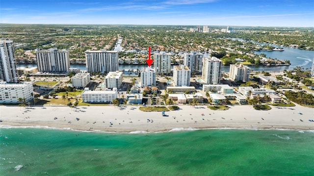 birds eye view of property featuring a view of the beach and a water view