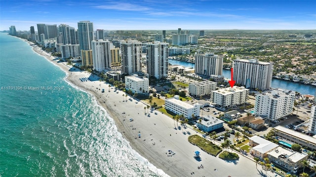 birds eye view of property featuring a water view and a view of the beach