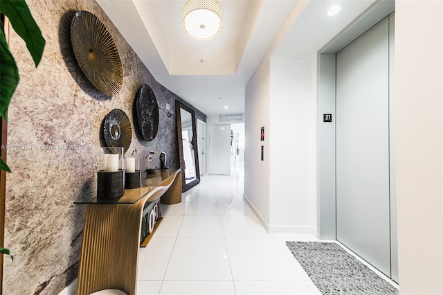 hallway featuring light tile patterned floors and elevator