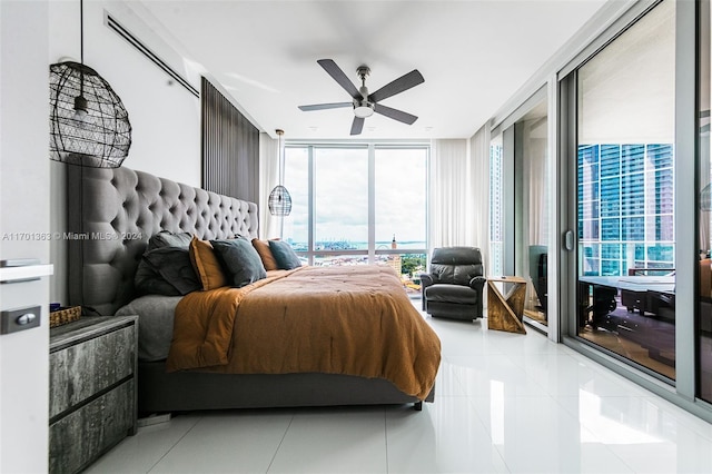 bedroom featuring light tile patterned flooring, expansive windows, and ceiling fan