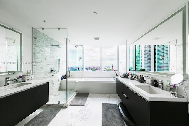 bathroom featuring vanity and separate shower and tub