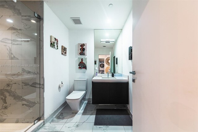 bathroom featuring vanity, toilet, and a shower with shower door