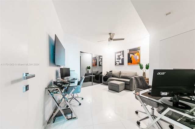 tiled office featuring ceiling fan