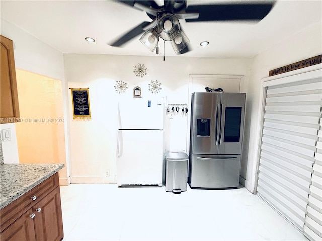 kitchen featuring white fridge, stainless steel fridge, light stone countertops, and ceiling fan