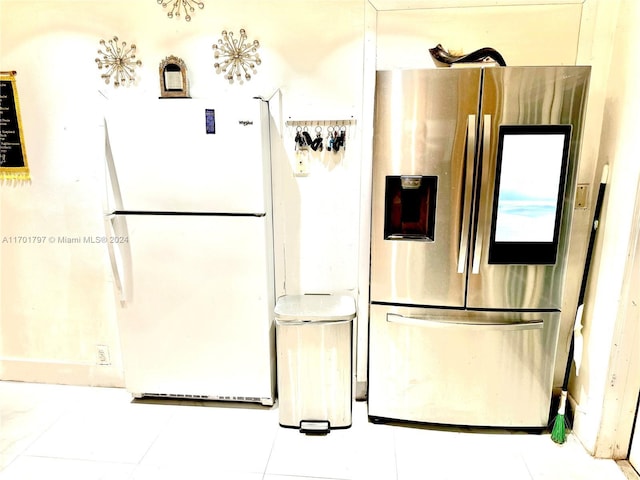 kitchen with white fridge and stainless steel fridge