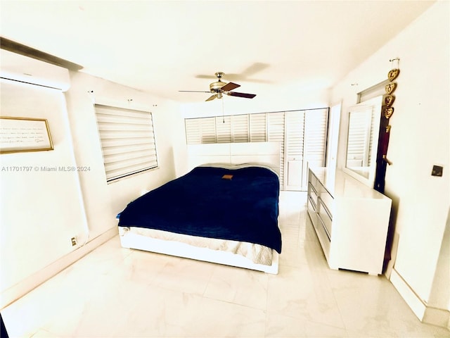 bedroom featuring a wall mounted air conditioner and ceiling fan