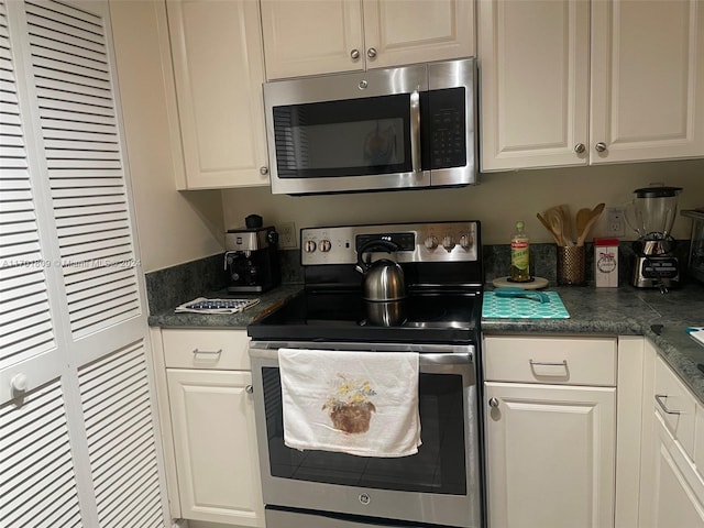 kitchen featuring white cabinetry and appliances with stainless steel finishes