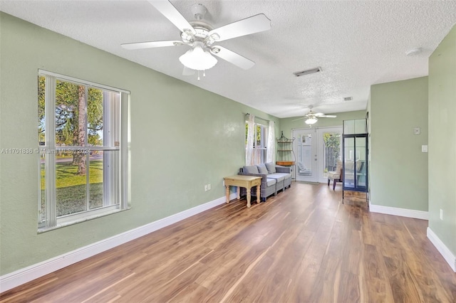 interior space featuring french doors, plenty of natural light, and hardwood / wood-style floors