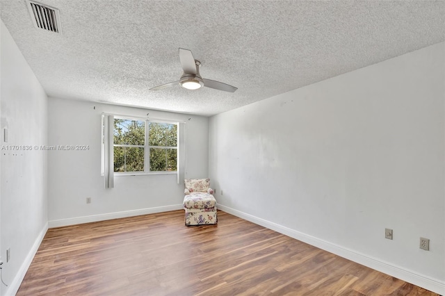 interior space with hardwood / wood-style floors, a textured ceiling, and ceiling fan