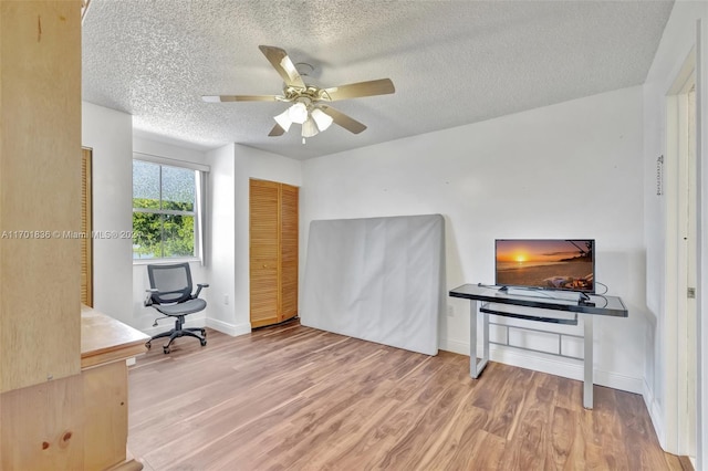 interior space featuring hardwood / wood-style floors, a textured ceiling, and ceiling fan