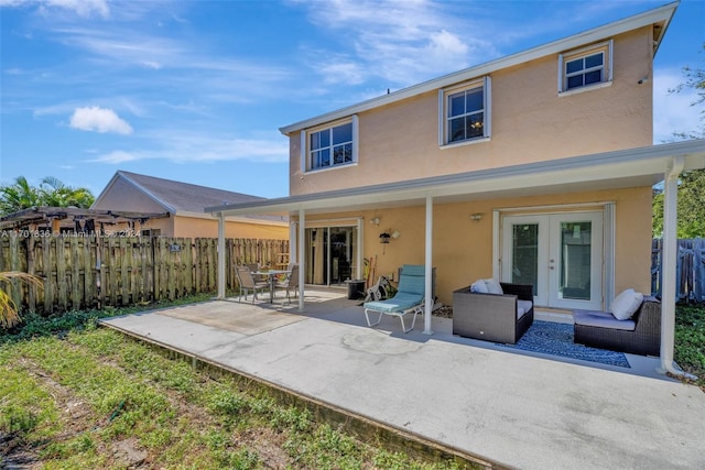 back of property with a patio area and french doors