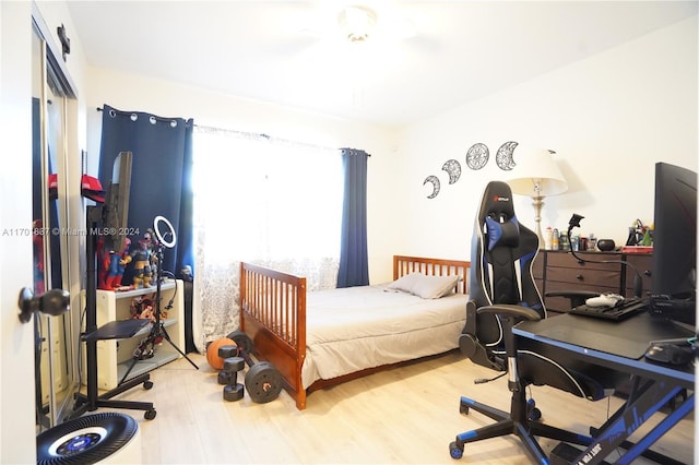 bedroom with a closet and hardwood / wood-style flooring