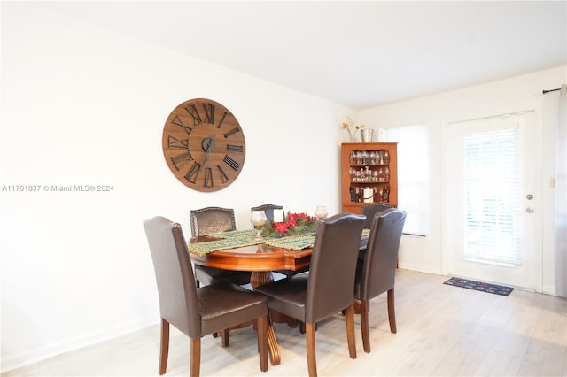 dining space with light hardwood / wood-style floors