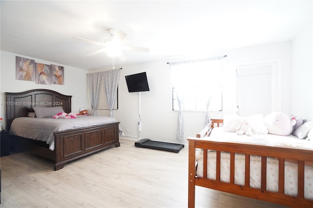 bedroom featuring light hardwood / wood-style flooring and ceiling fan