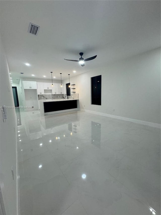 unfurnished living room featuring marble finish floor, recessed lighting, visible vents, ceiling fan, and baseboards