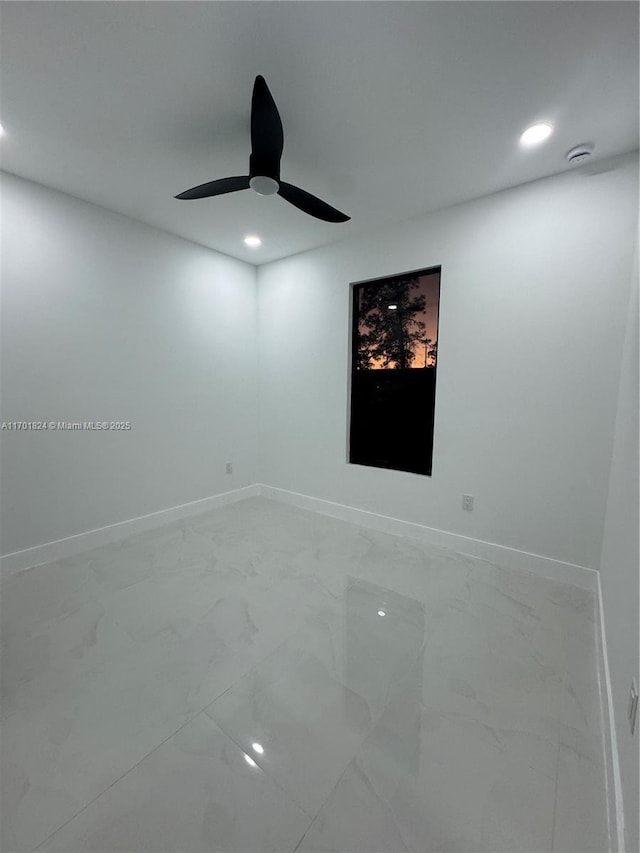 spare room featuring recessed lighting, marble finish floor, ceiling fan, and baseboards