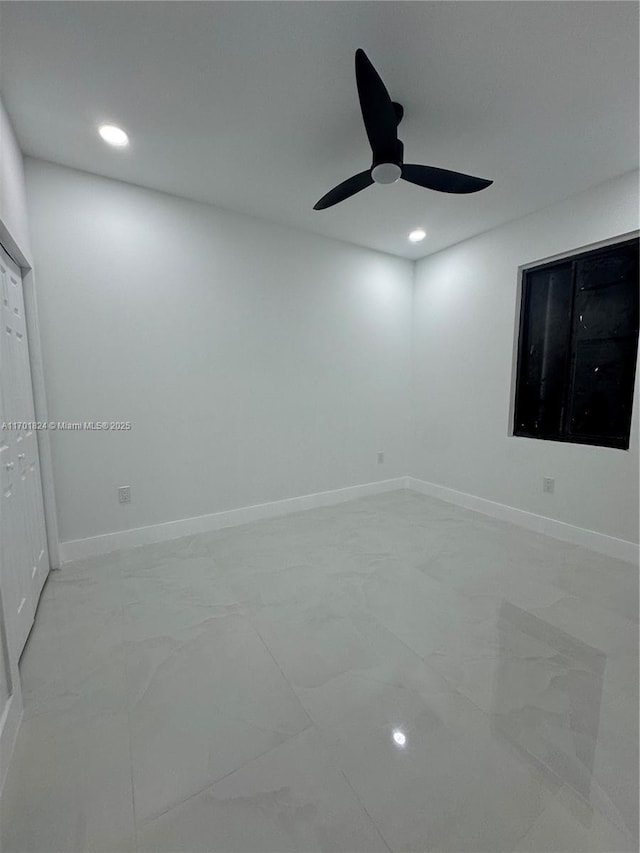 unfurnished bedroom featuring marble finish floor, baseboards, and recessed lighting