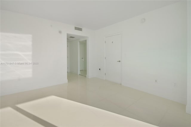 spare room featuring tile patterned flooring