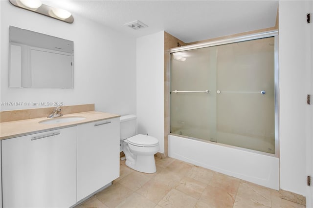 full bathroom featuring vanity, enclosed tub / shower combo, and toilet