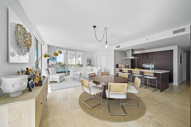 dining room with light tile patterned flooring and sink