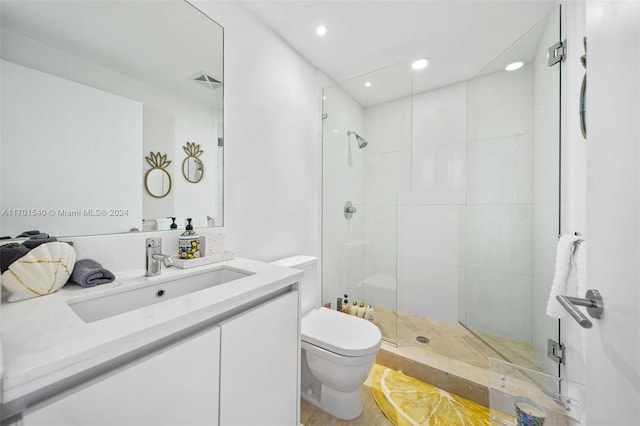 bathroom featuring hardwood / wood-style floors, vanity, toilet, and a shower with shower door