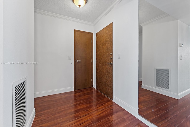 hallway with dark hardwood / wood-style flooring, crown molding, and a textured ceiling