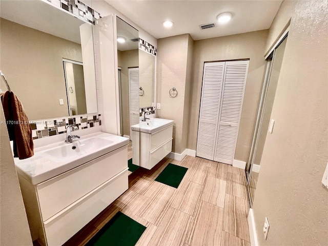 bathroom featuring hardwood / wood-style floors, vanity, and backsplash