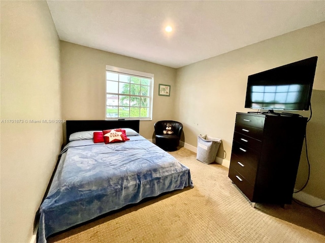 bedroom featuring light colored carpet