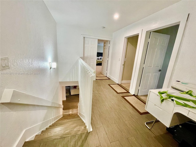 stairway featuring hardwood / wood-style flooring