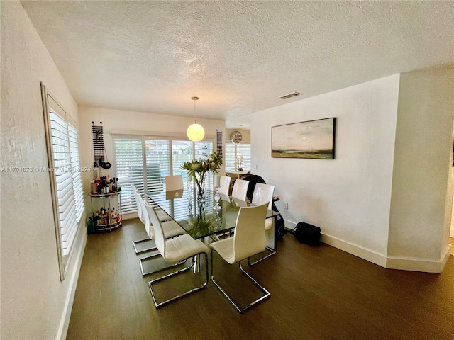 dining space with a textured ceiling