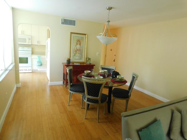 dining area featuring light wood-type flooring