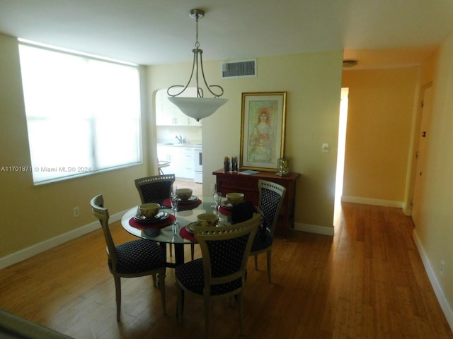 dining room featuring hardwood / wood-style flooring and sink