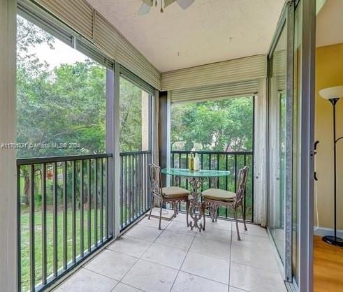 sunroom / solarium featuring ceiling fan and a wealth of natural light