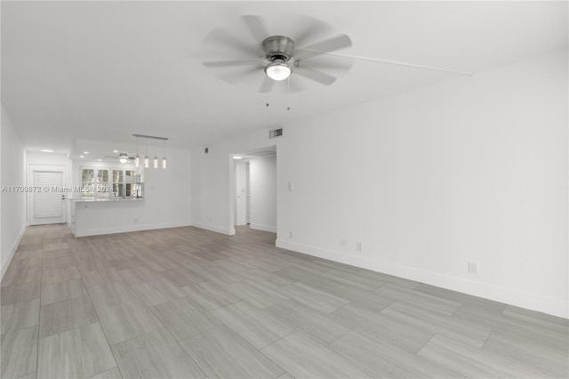 unfurnished living room featuring ceiling fan