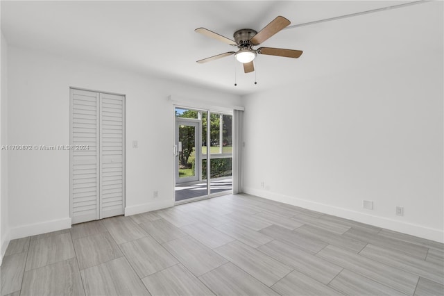 unfurnished bedroom with ceiling fan, access to outside, and a closet