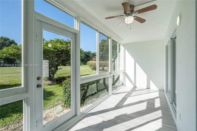 sunroom featuring a wealth of natural light and ceiling fan