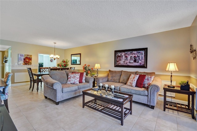 tiled living room featuring a chandelier and a textured ceiling