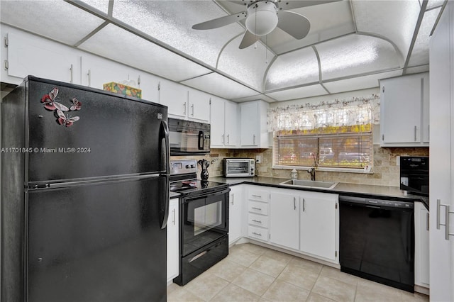 kitchen with sink, light tile patterned floors, tasteful backsplash, white cabinets, and black appliances