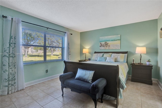 bedroom featuring light tile patterned flooring and a textured ceiling