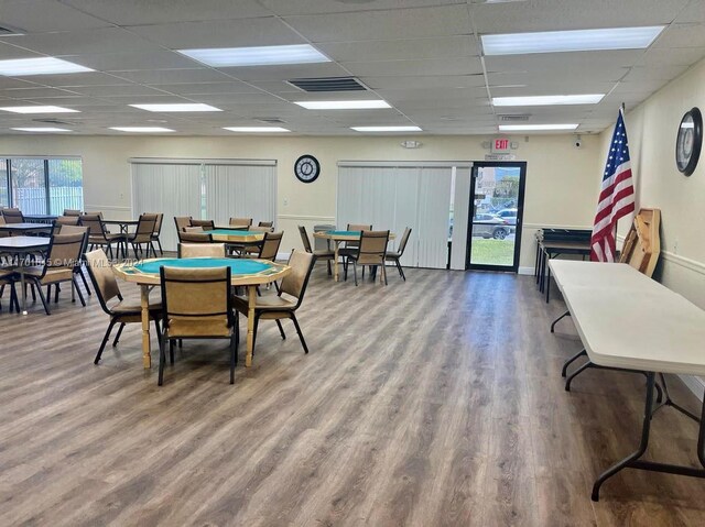 game room featuring a paneled ceiling and hardwood / wood-style floors