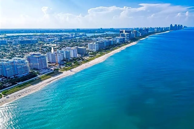 drone / aerial view featuring a view of the beach and a water view