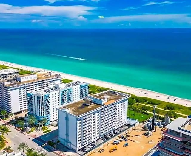 drone / aerial view featuring a water view and a beach view