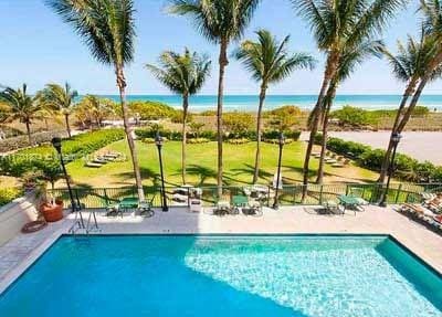 view of swimming pool featuring a water view and a patio area