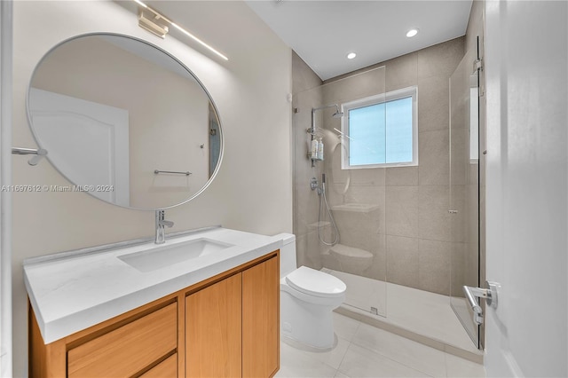 bathroom featuring tile patterned flooring, vanity, toilet, and a shower with door