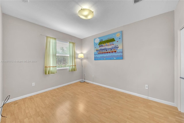 empty room featuring wood-type flooring