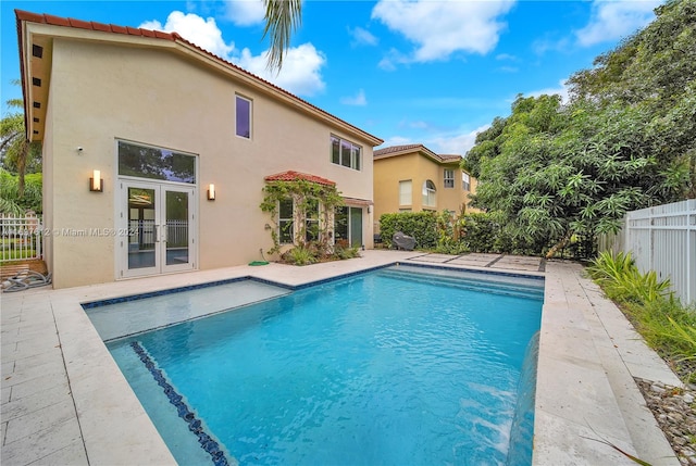 view of pool with french doors