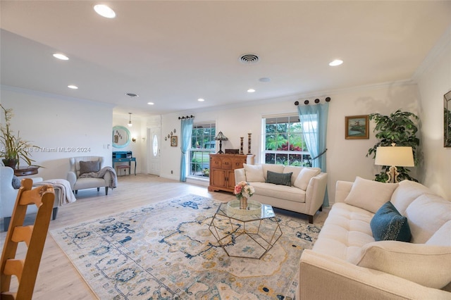 living room featuring light wood-type flooring and crown molding