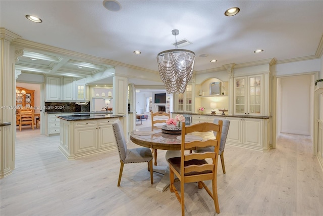 dining space with a chandelier, light hardwood / wood-style floors, and crown molding