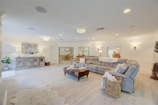 living room with light wood-type flooring and crown molding