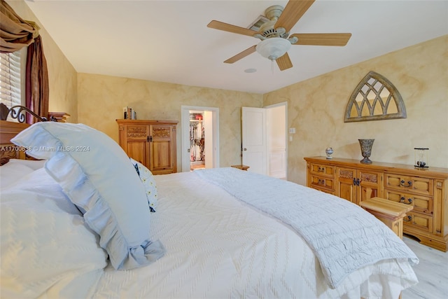 bedroom featuring ceiling fan and ensuite bathroom